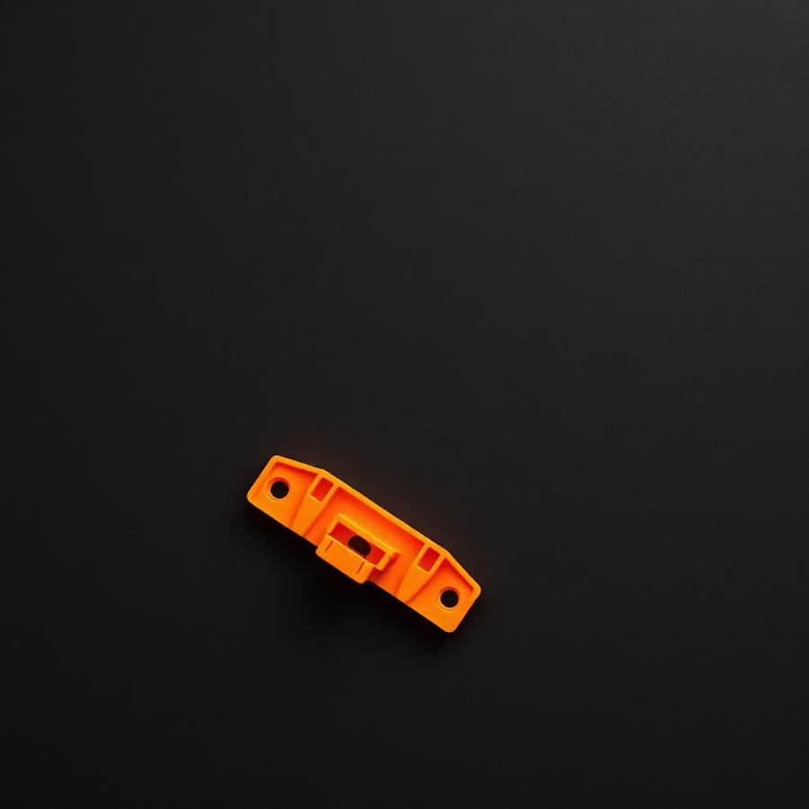 Orange 3D printed mounting bracket with two screw holes